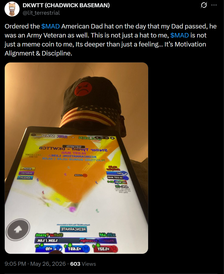 DKWTT wearing $MAD American Dad hat with MAD game on tablet